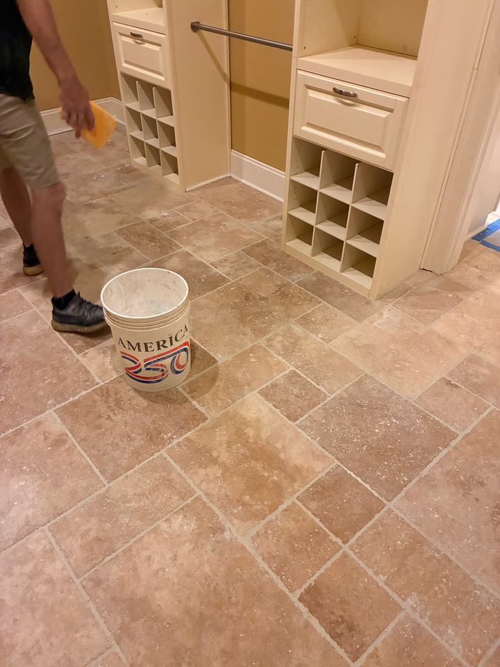 Grouting a travertine floor in a walk-in closet